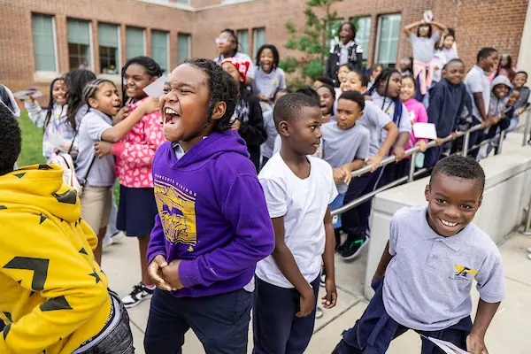 Elementary school students excited to see the Ravens players and mascot