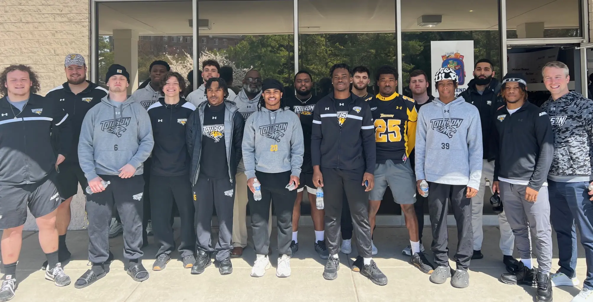 Towson football team members posed outside of Weekend Backpack's facility.