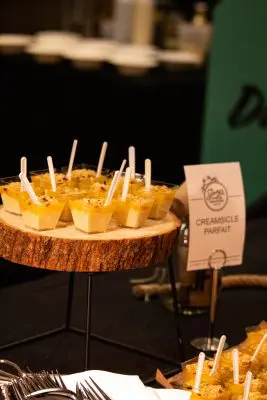 A tray of cups of food with a sign saying "Creamsicle Parfait."