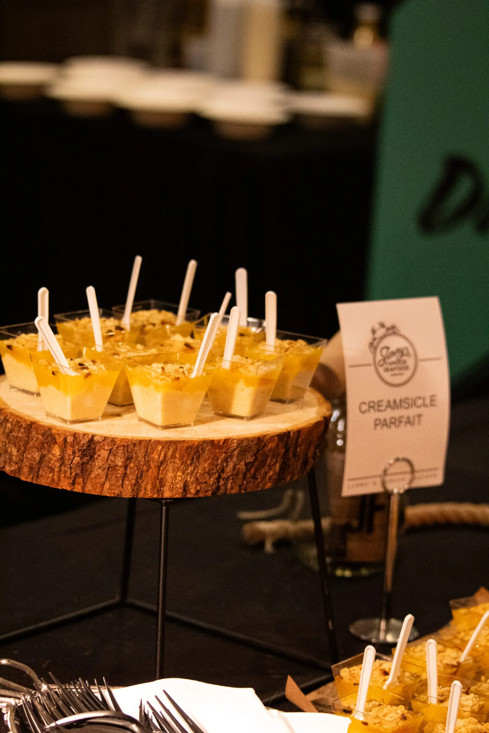 A tray of cups of food with a sign saying "Creamsicle Parfait."