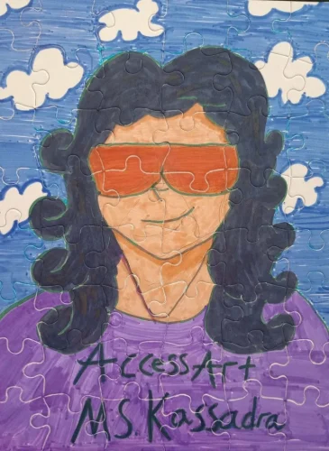 A puzzle with a child's drawing of a woman with handwriting that says "access art Ms. Kassadra."