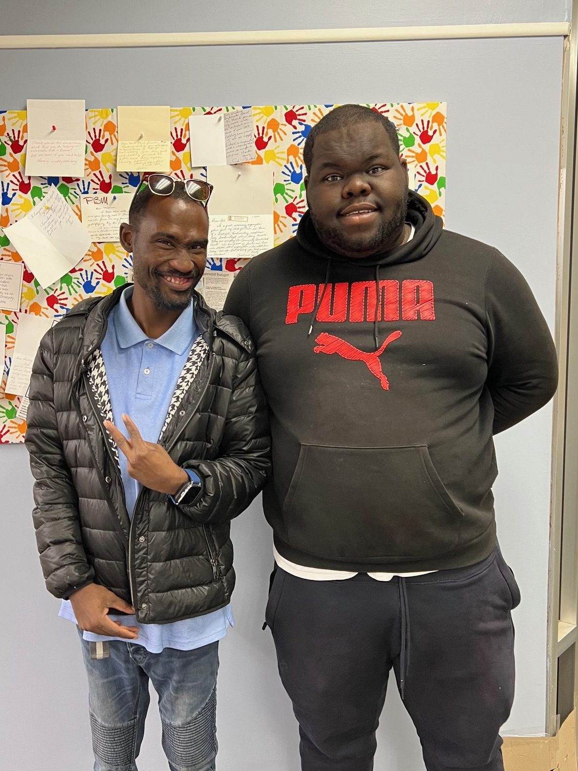 Two young men smiling.